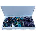 3 large multicoloured animal print silk scrunchies in a light blue box on a white background