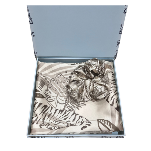 Gold tiger print silk pillowcase and matching silk scrunchie on a white background 