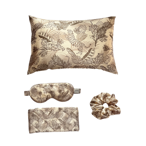 Gold tiger print silk pillowcase, matching silk scrunchie, silk eye mask and travel case on a white background 