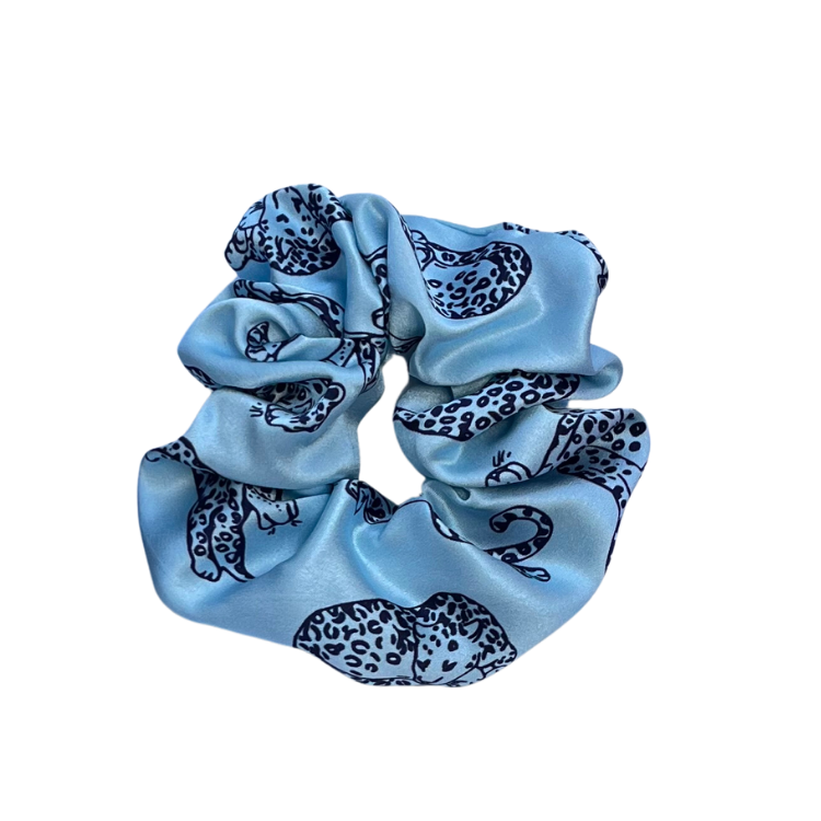 Light Blue leopard printed silk scrunchie on a white background