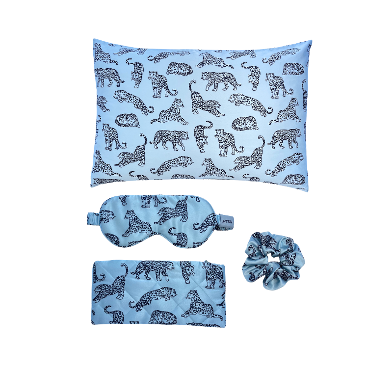 MYRN Silk light blue leopard printed silk pillowcase, silk scrunchie, eye mask and silk travel case on a white background