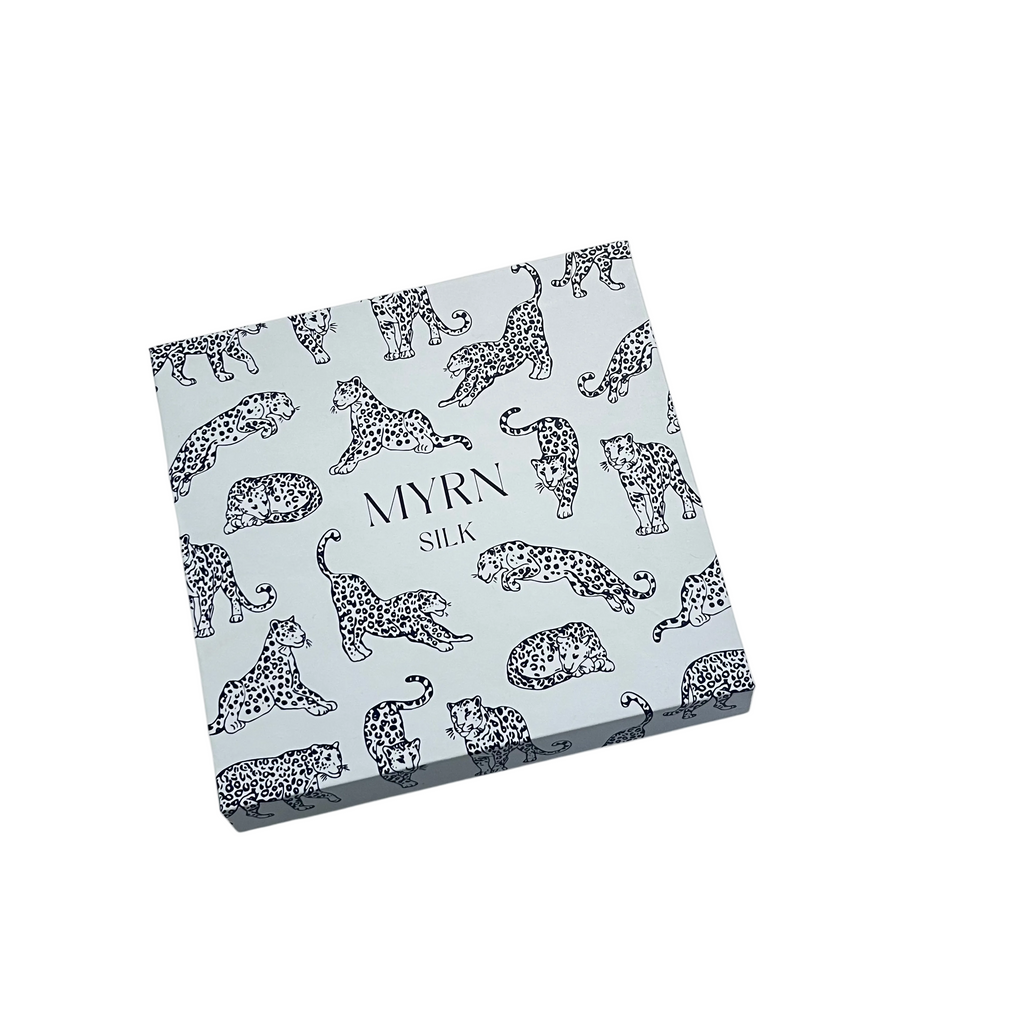 MYRN Silk light blue leopard print branded gift box for a pillowcase and scrunchie set.